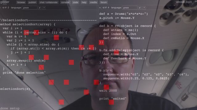 James Noble reflected on screen behind code.