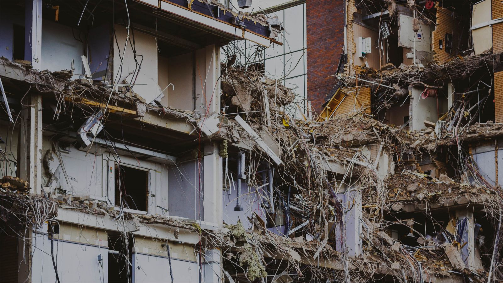 Partially demolished buildings with their interiors exposed to the elements.