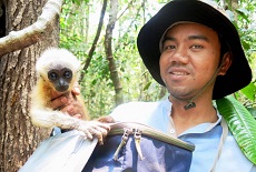 Baby gibbon on the shoulders of student Naven Hon