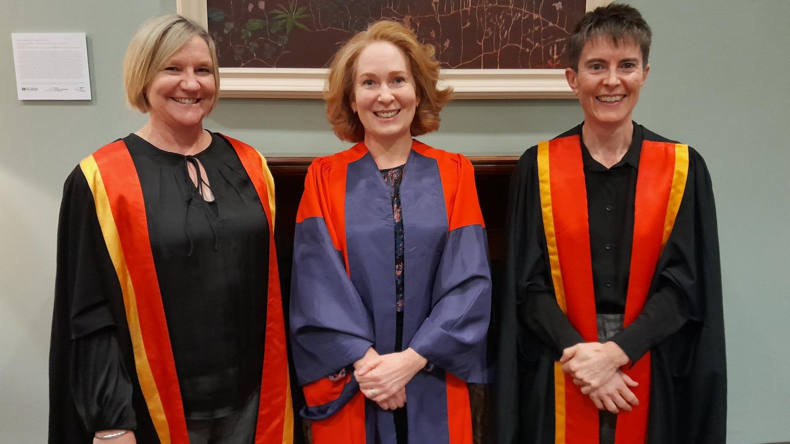 Sarah Ross, flanked by two other academics, dressed in gowns at her inaugural lecture.