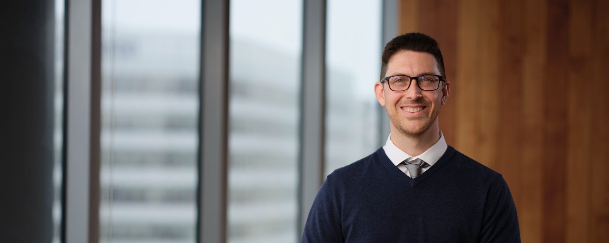 Portrait of a man in business clothing smiling at the camera.