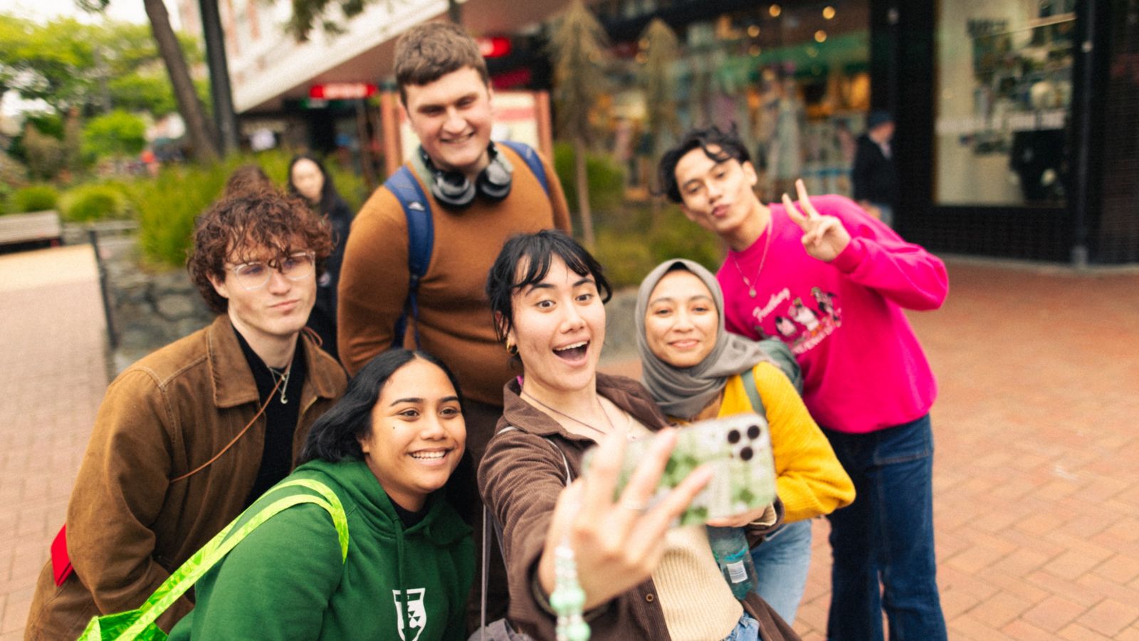 A group of six students taking a selfie on Cuba St