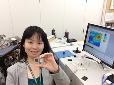 Dr Ying Tang holding two hair samples in a laboratory. 