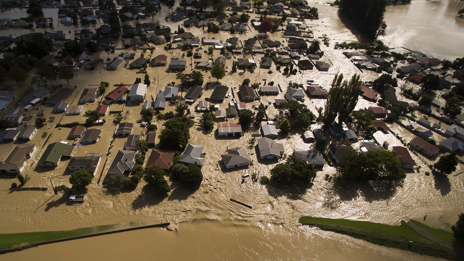 Aerial shot of suburb flooded with muddy water