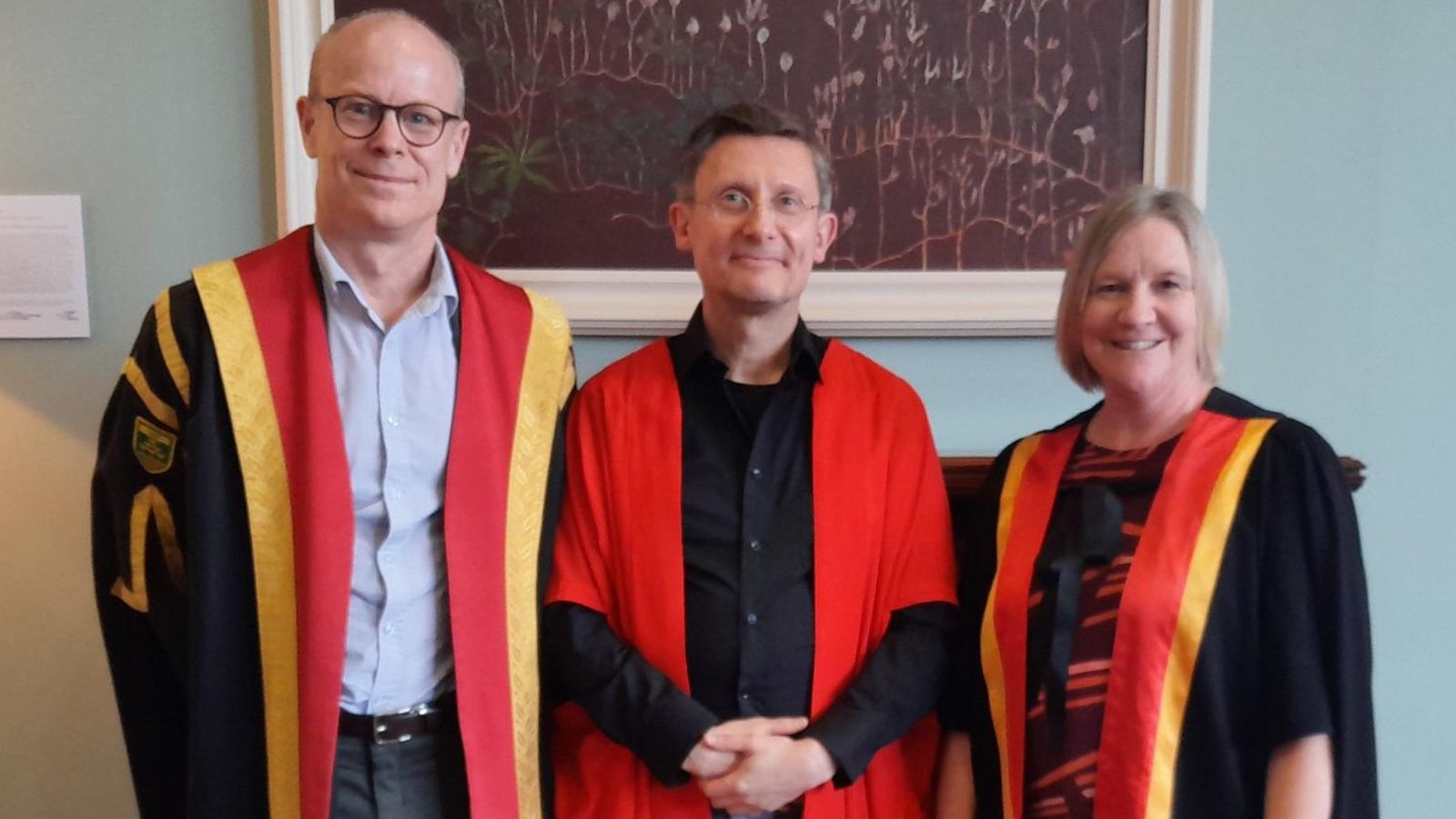 Three people in academic garb