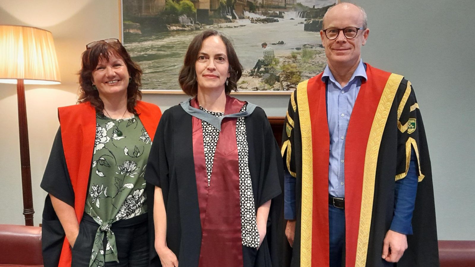 Rebecca Priestley, dressed in academic robes, with Nic Smith and another academic at her inaugural lecture.