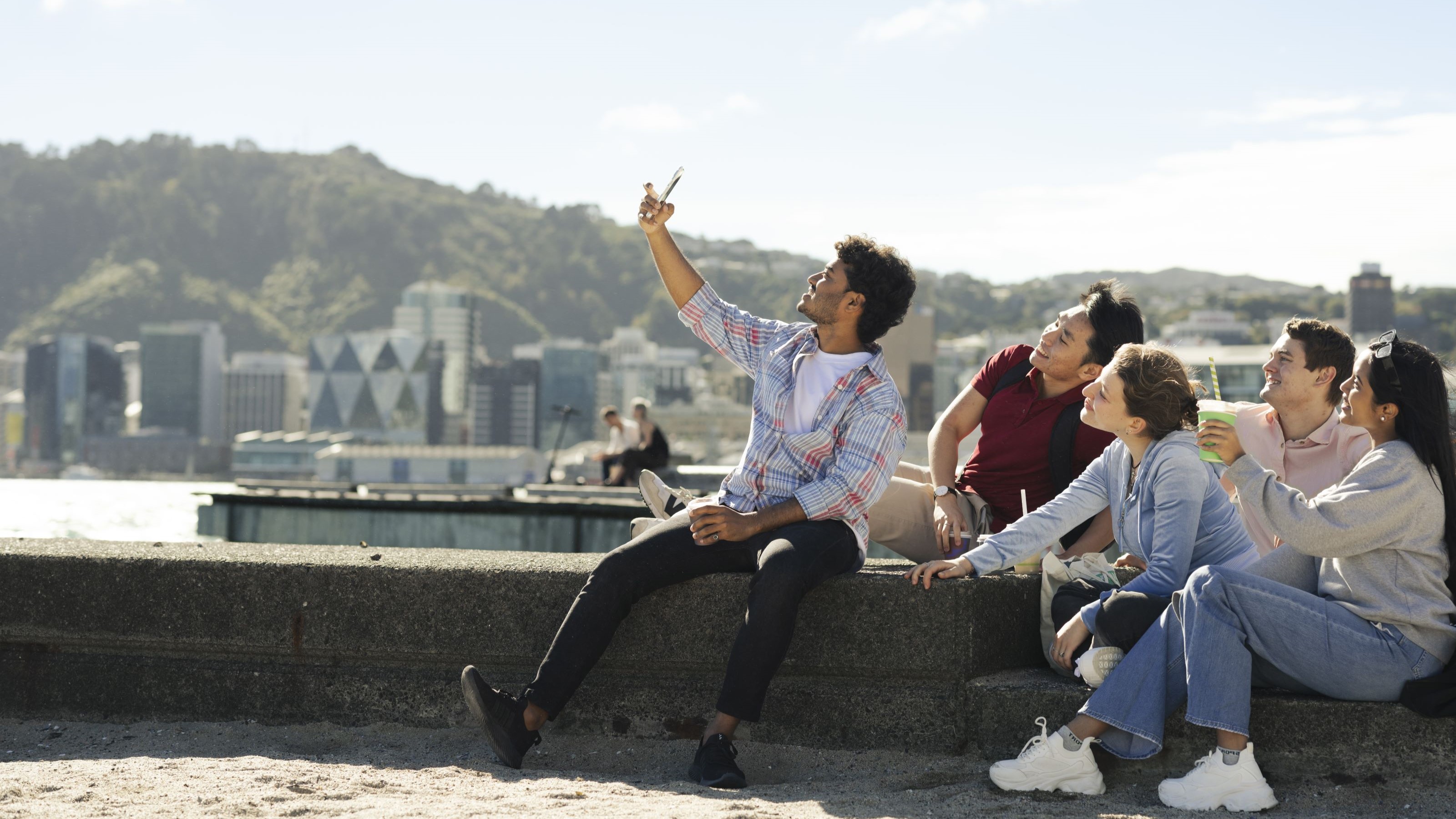 Group of students sitting together in beach area