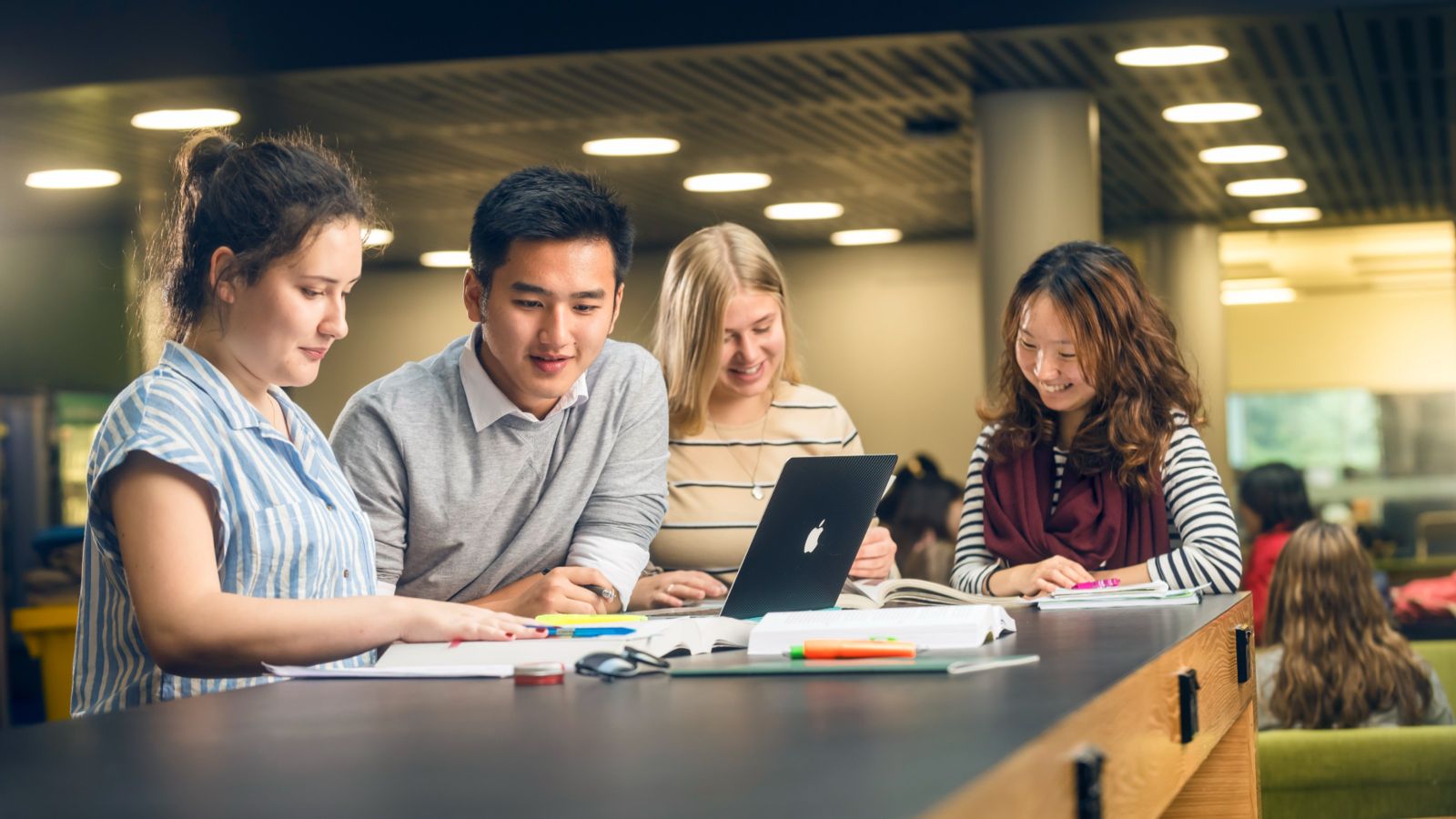 Four people working together at table