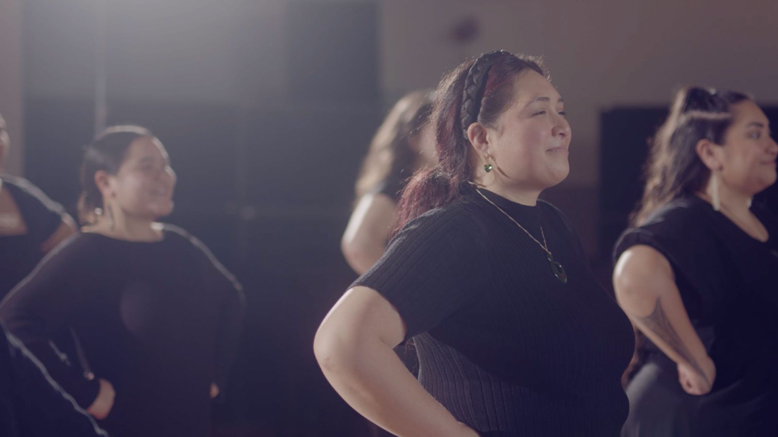 A group of women with their hands on their hips performing.