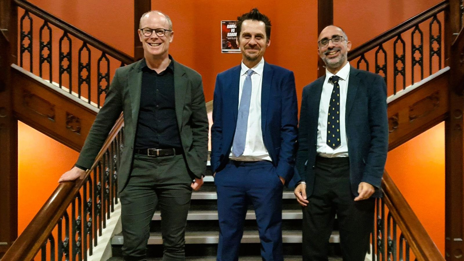 Three men standing on the stairs in the Hunter building