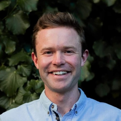 A smiling man in a blue shirt.