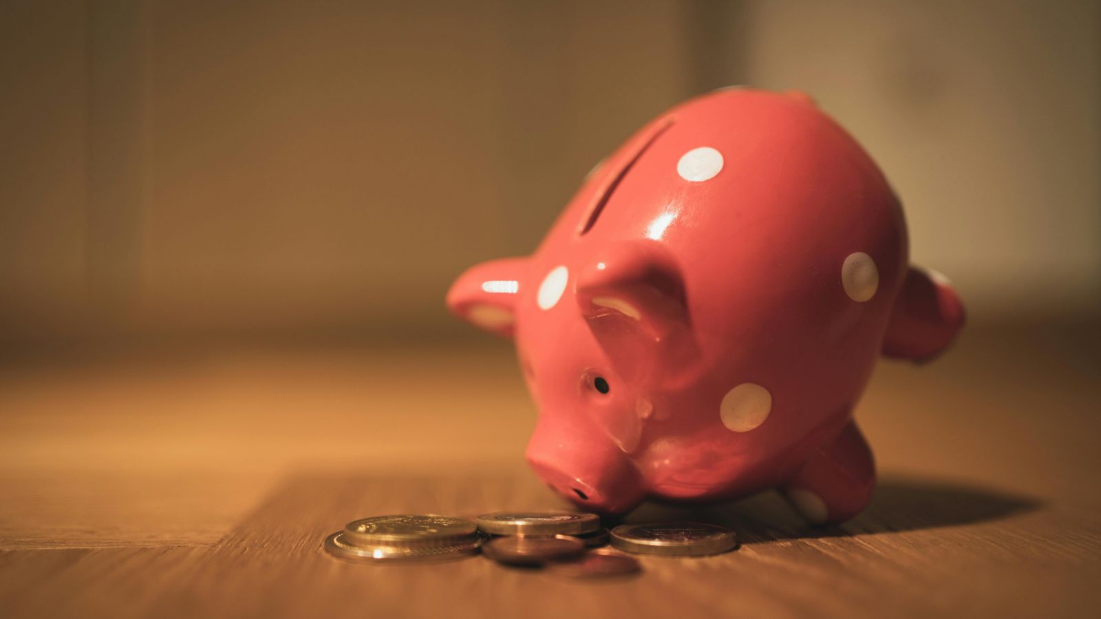 Piggy bank next to coins 