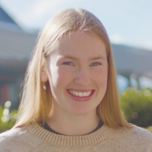 A profile picture of Hannah, with sunny glare in the background