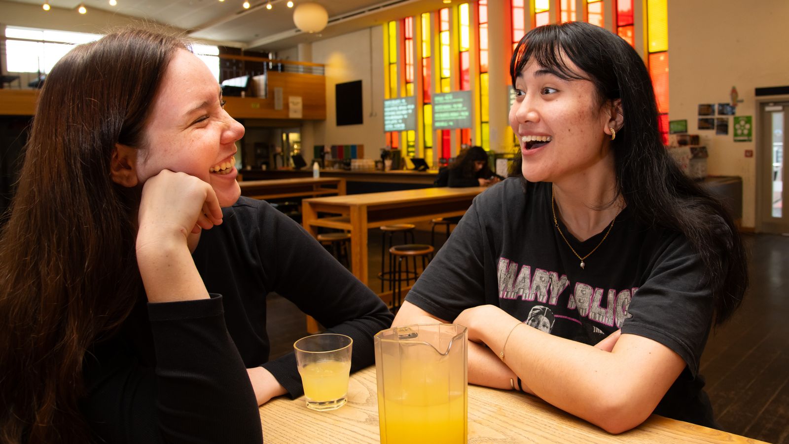 Two students hanging out in the Hunter lounge