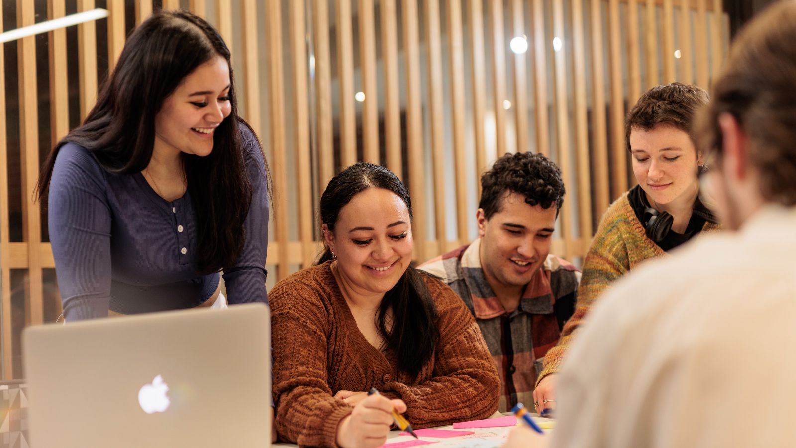 Group of students sitting around a table.