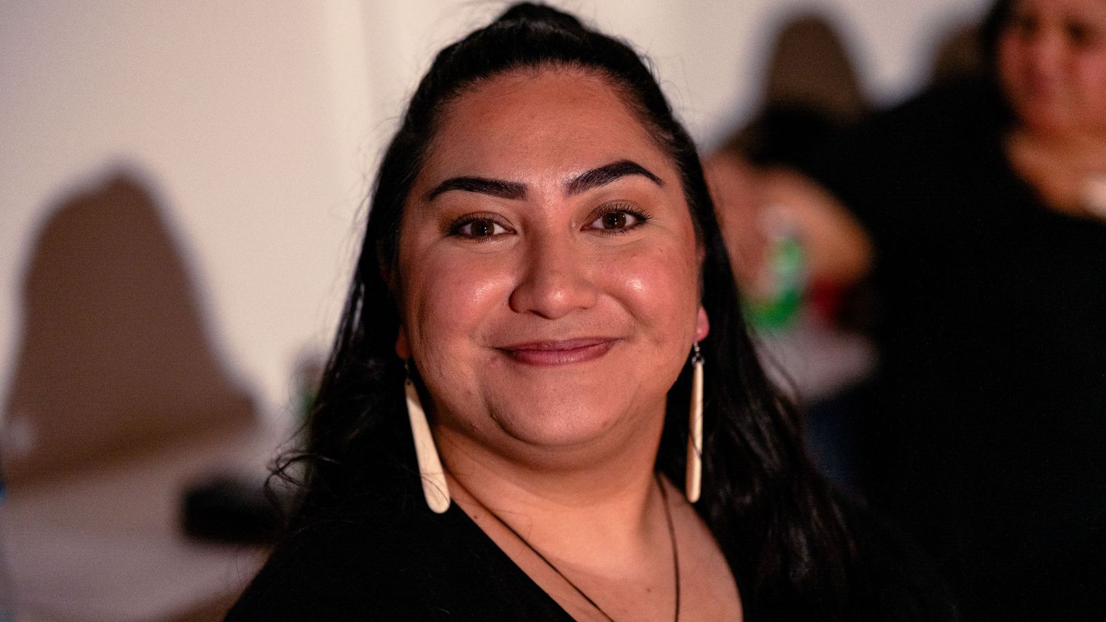 A close up of a smiling woman's face.