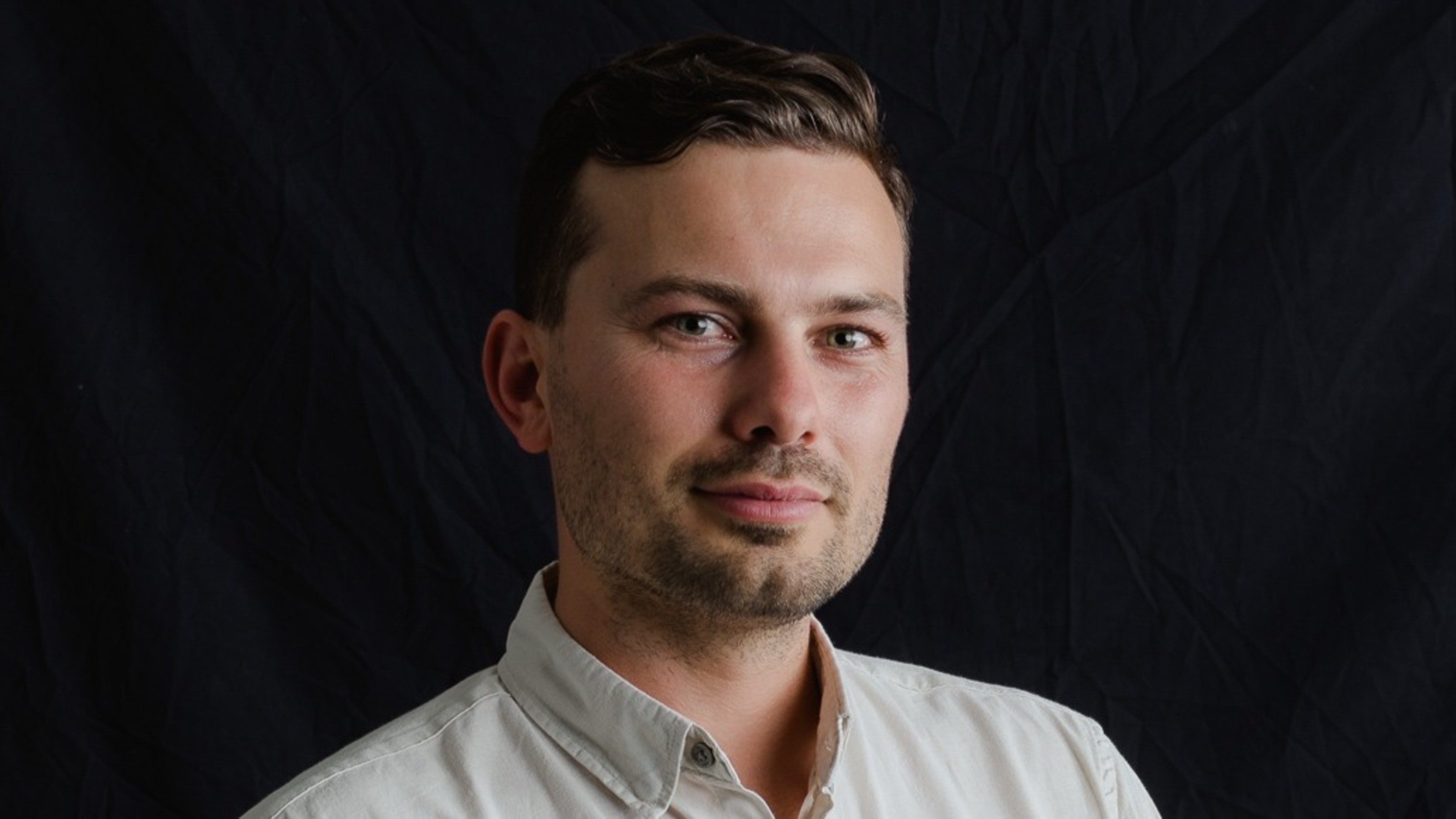 A profile photo of Benjamin Johnson, wearing a white shirt