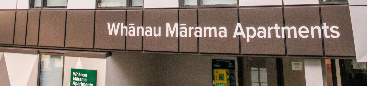 Whānau Mārama Apartments exterior and signage