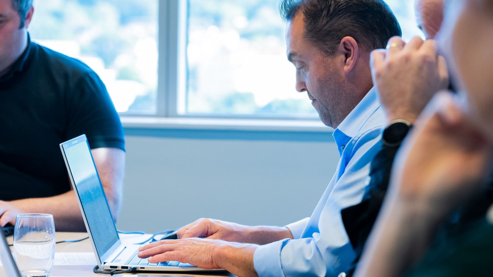 Photo of Professor Jarrod Haar using his laptop in a meeting