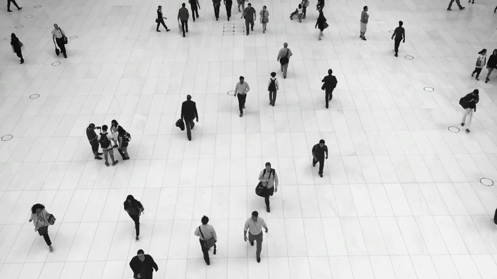 Aerial view of pedestrians walking in various directions in a public square