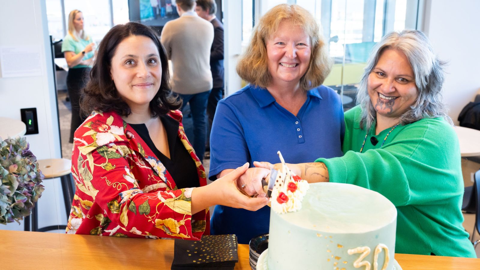 Kirsten Smiler, Jackie Cummings, and Lynne Russell cut the celebratory cake at the thirtieth party