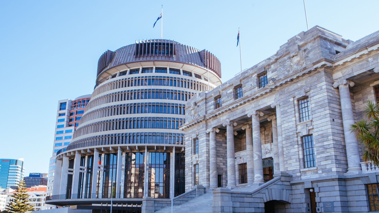 Wellington Government beehive with Government house on the right-side and blue skies surrounding.