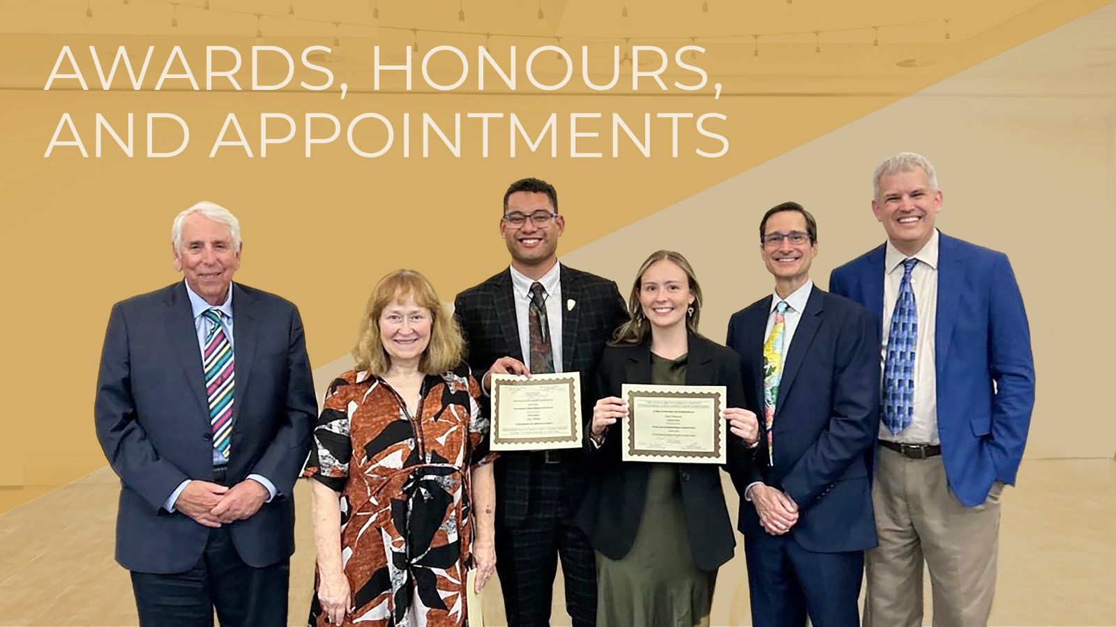 a group of people holding awards