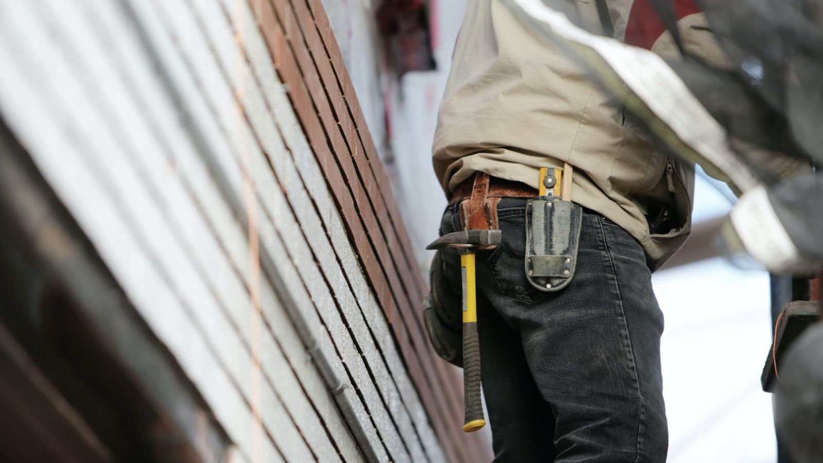 Man wearing tool belt at building site