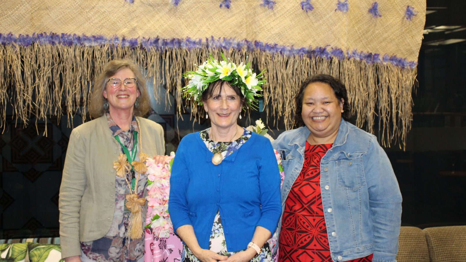 three women, one wearing floral crown