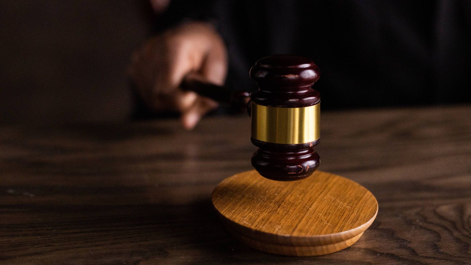 Wooden gavel on brown table