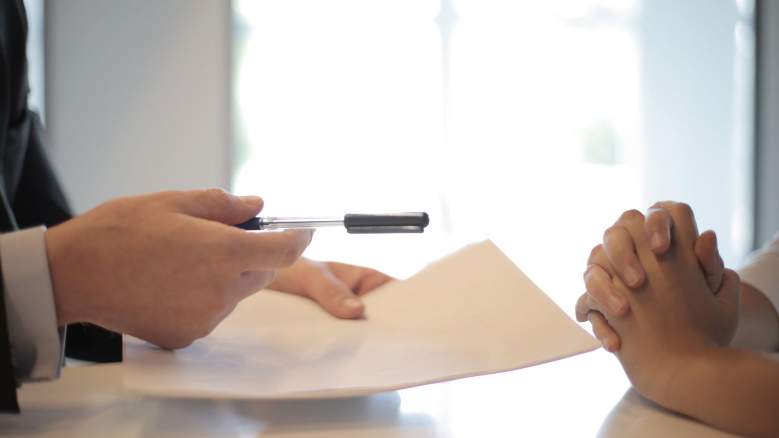 Man giving woman a contract to sign