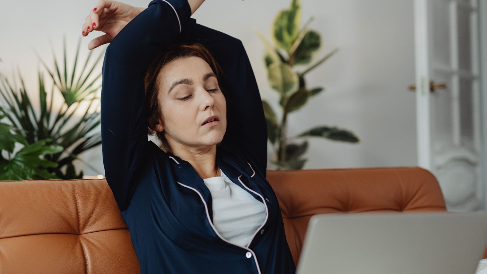 Tired woman working at laptop