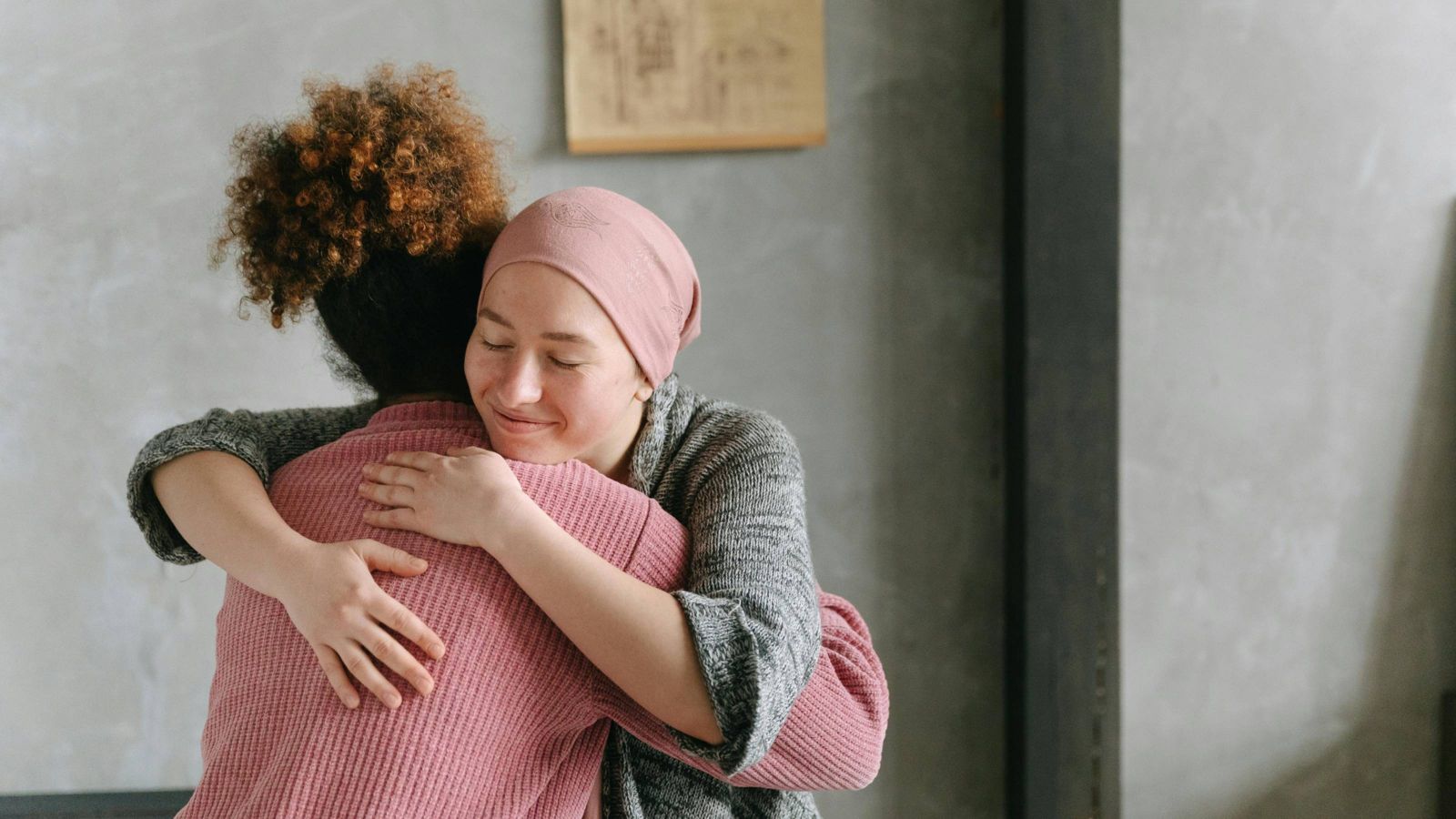 Two women, one who is unwell, embracing  