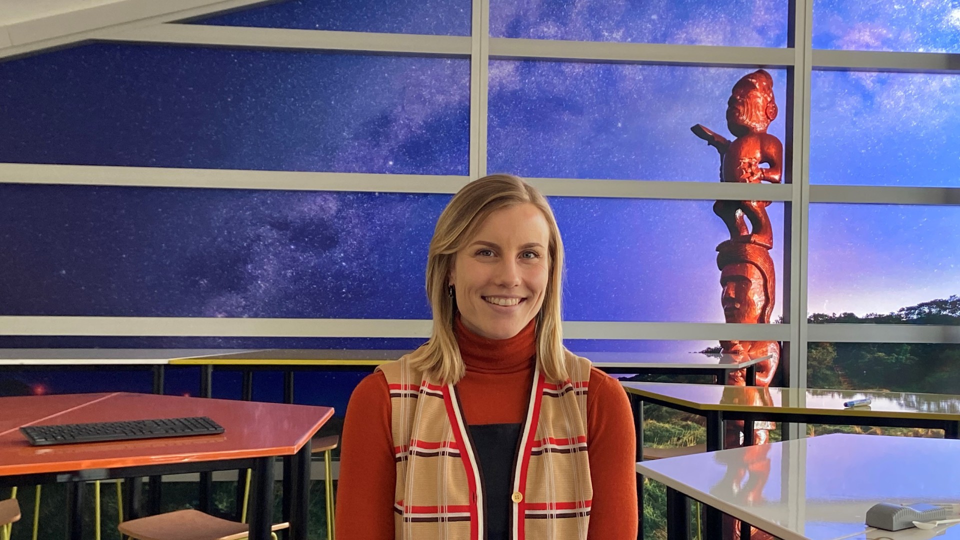 Woman smiling at camera in front of night sky back drop