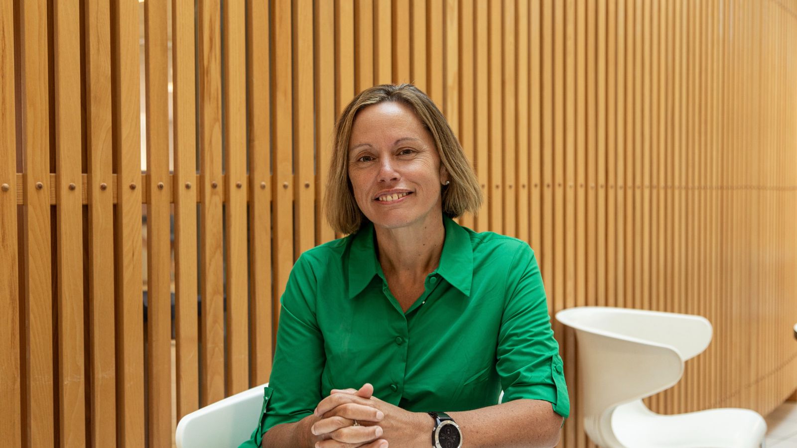 Woman seated and smiling at camera 