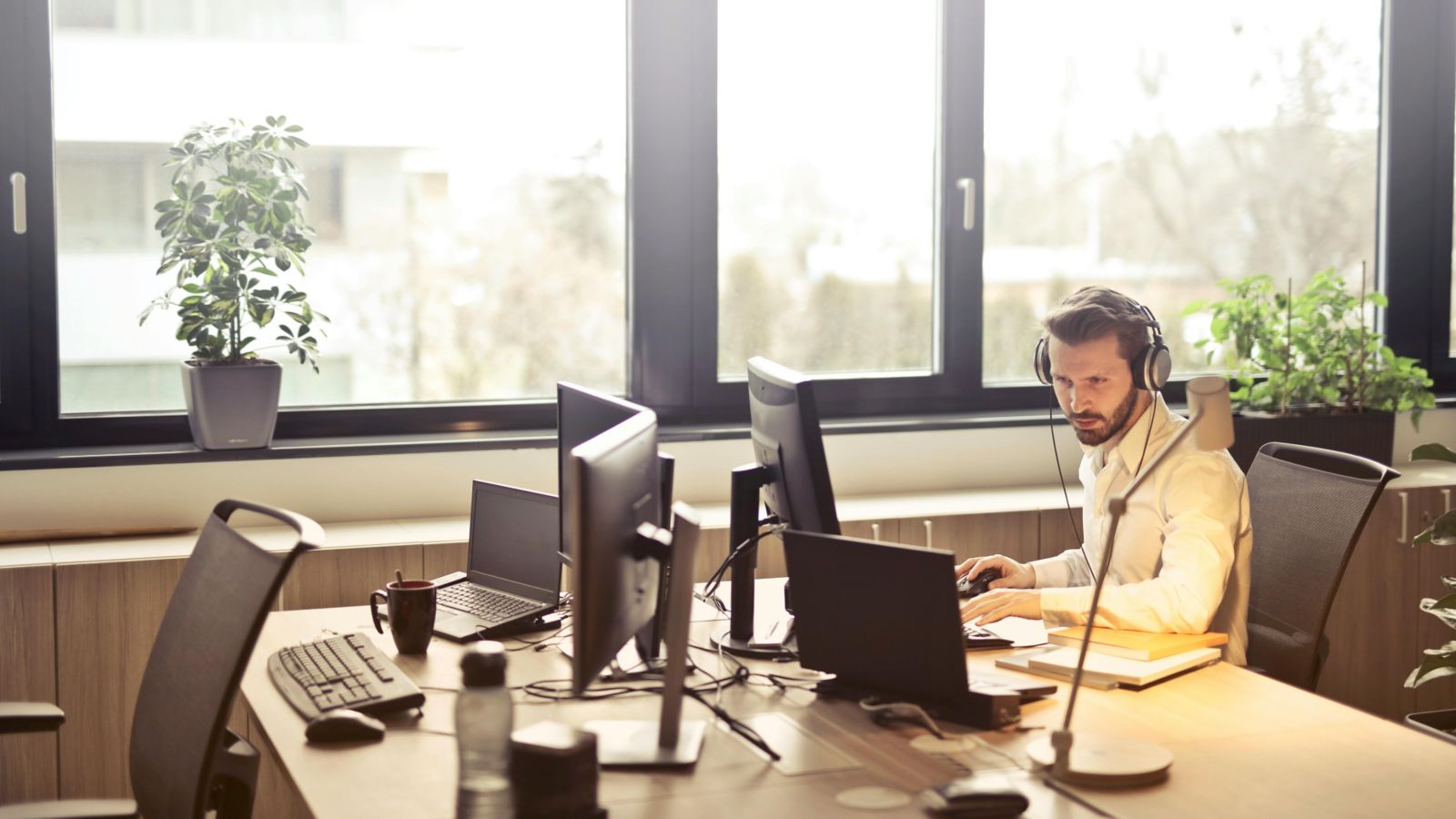 Person working at computer with headphones on 