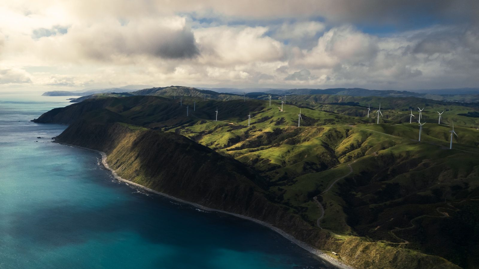 An overhead view of the wind farm on the hills of Makara with the ocean. 