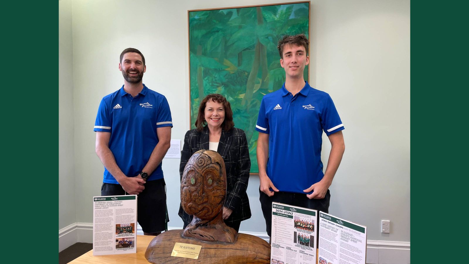 Two men and a woman stand behind Te Kaitiaki