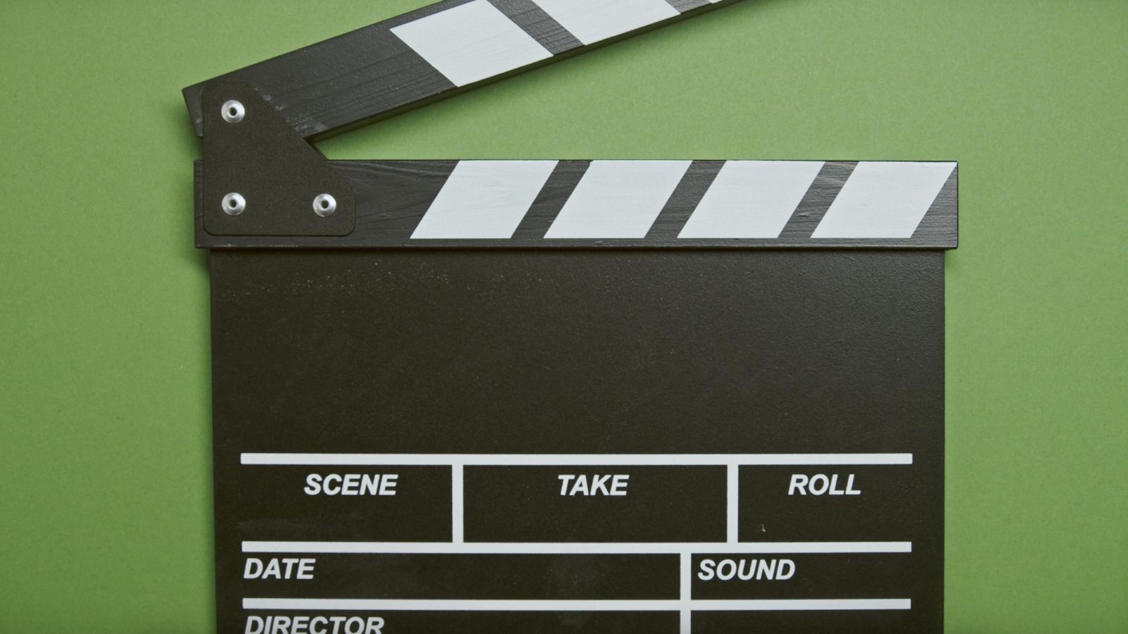 Clapperboard against a green background 