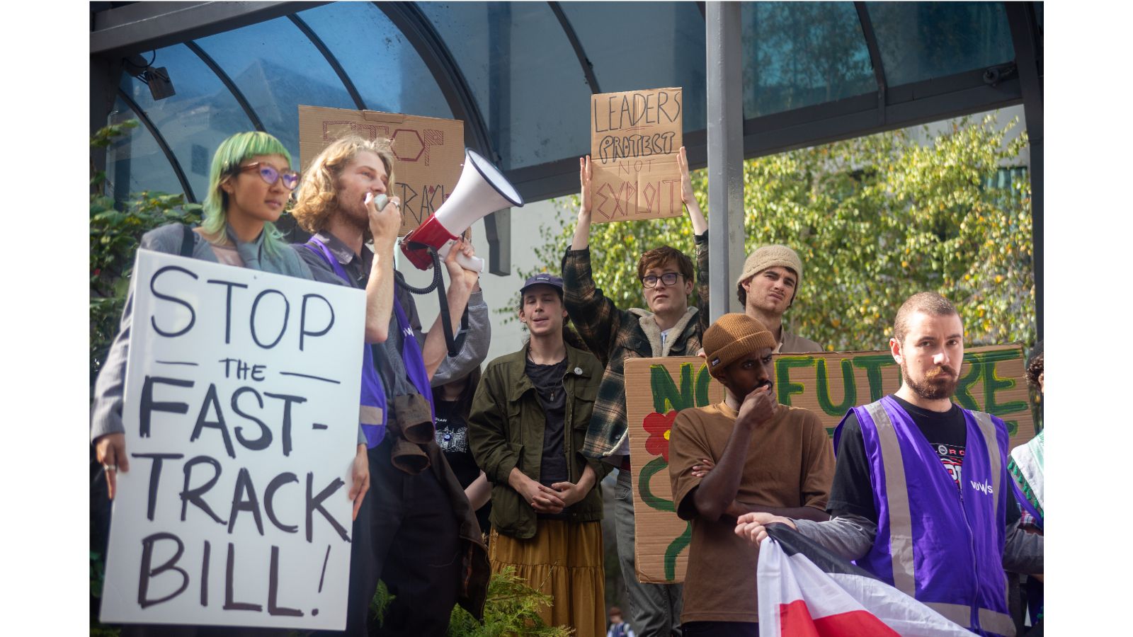 A group of protesters, a placard reads 