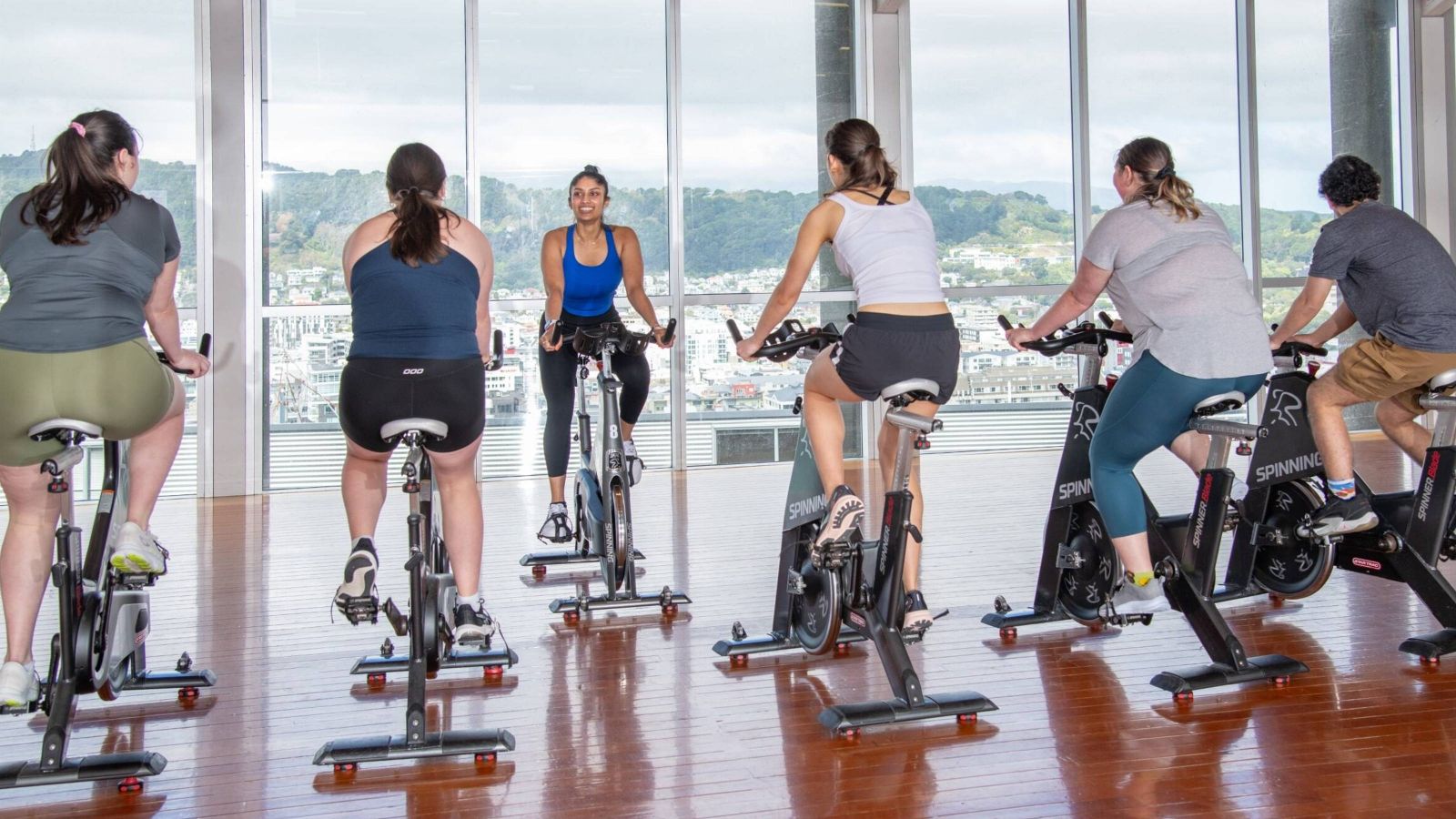 Group of people participating in a Spin Class with an instructor 