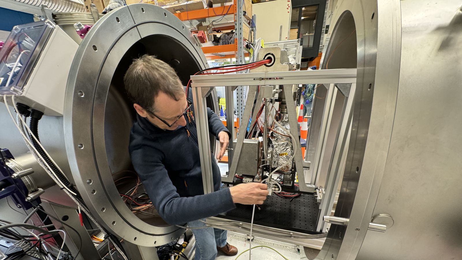 Emile Webster works on vacuum chamber